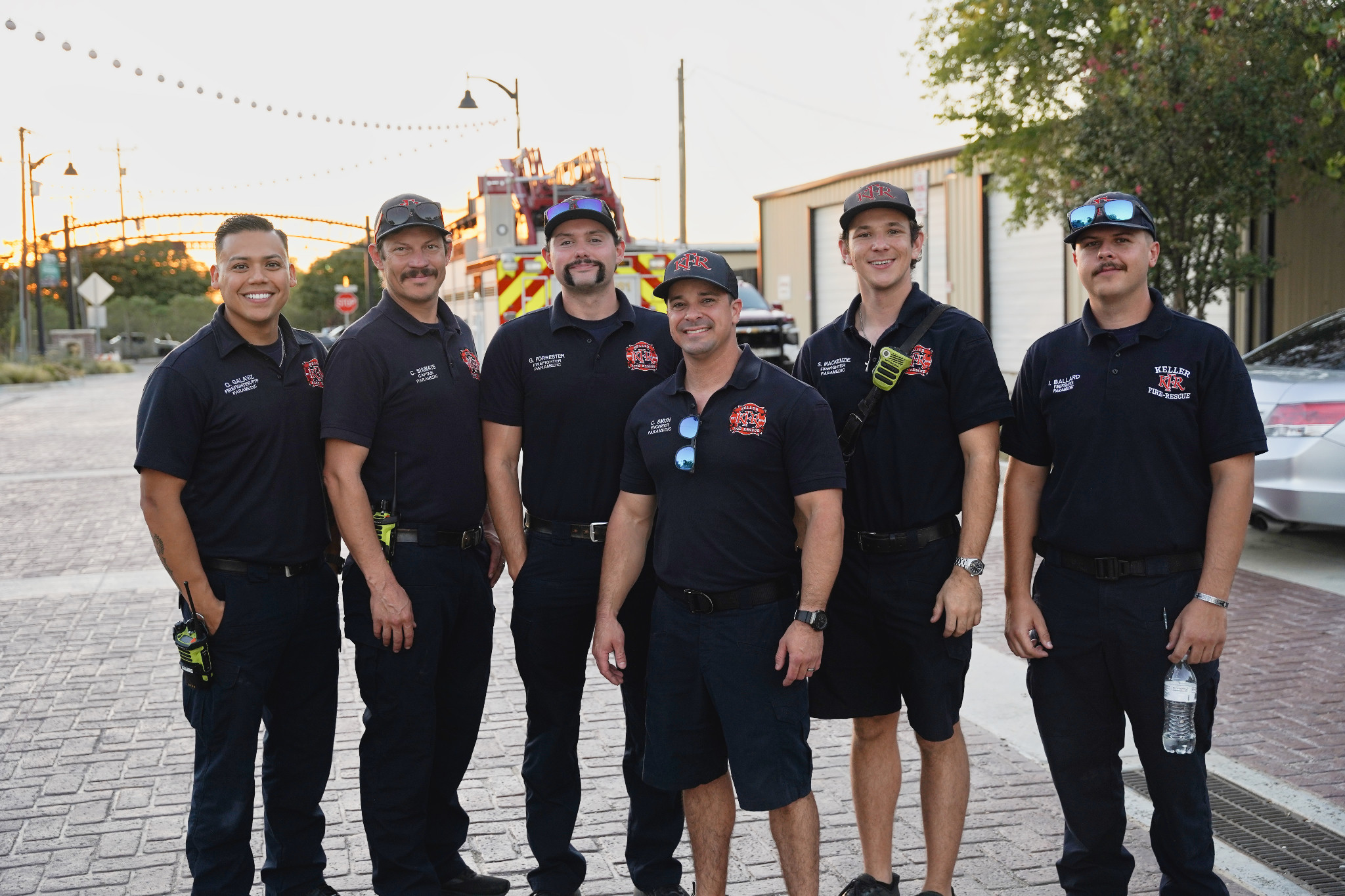 Six members of Keller Fire Rescue stand together on Bates Street, with a fire truck behind them.