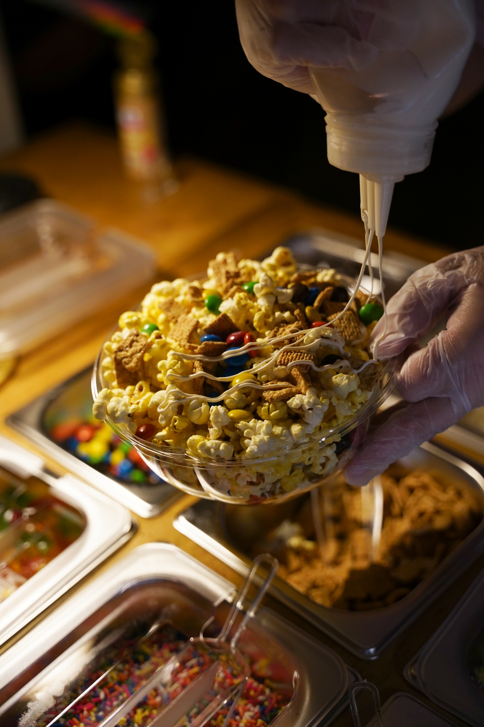 A finishing drizzle is added to popcorn and toppings at The Grazing Cavi’s September 25 Depot Nights popcorn bar.